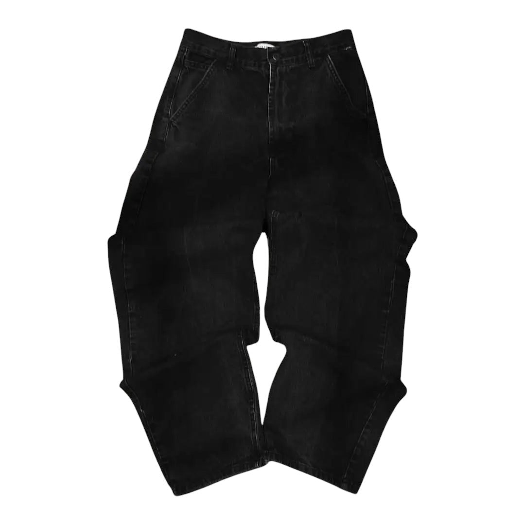 AuraXclusive black baggy denim jeans with a loose wide-leg fit and vintage wash, laid flat on a textured grey surface.