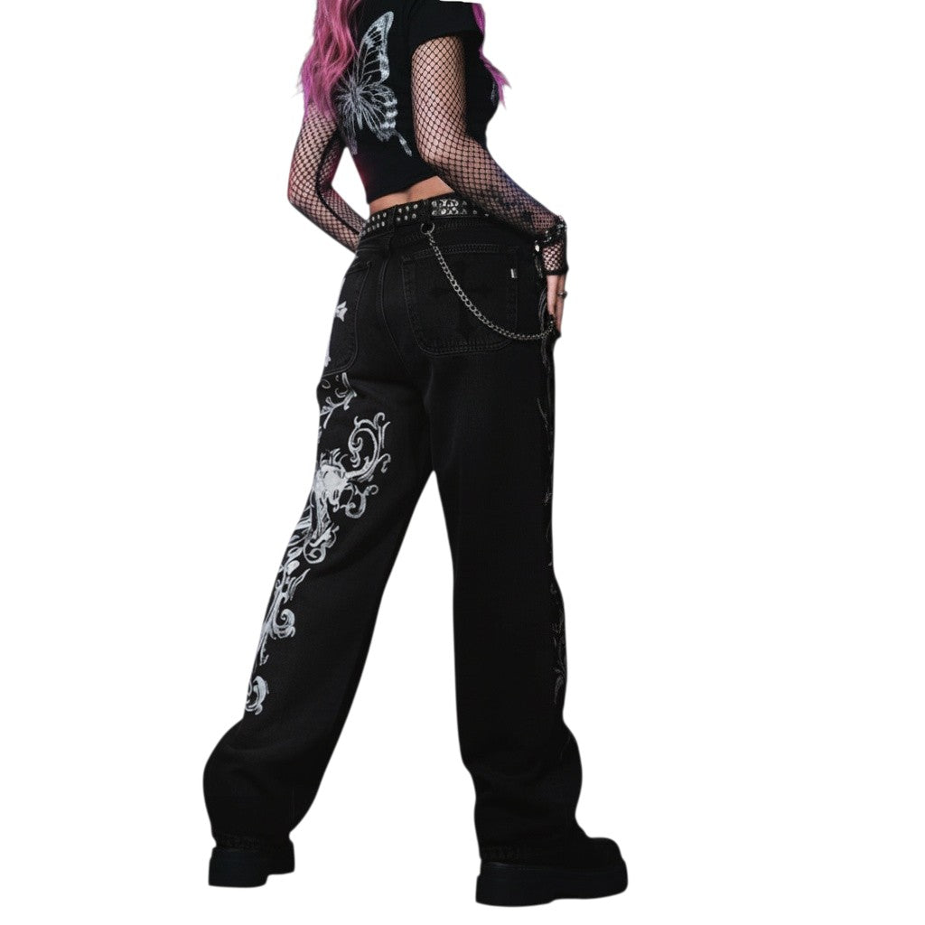 AuraXclusive black baggy denim jeans with intricate white embroidery and chain detail in a Y2K hip hop style