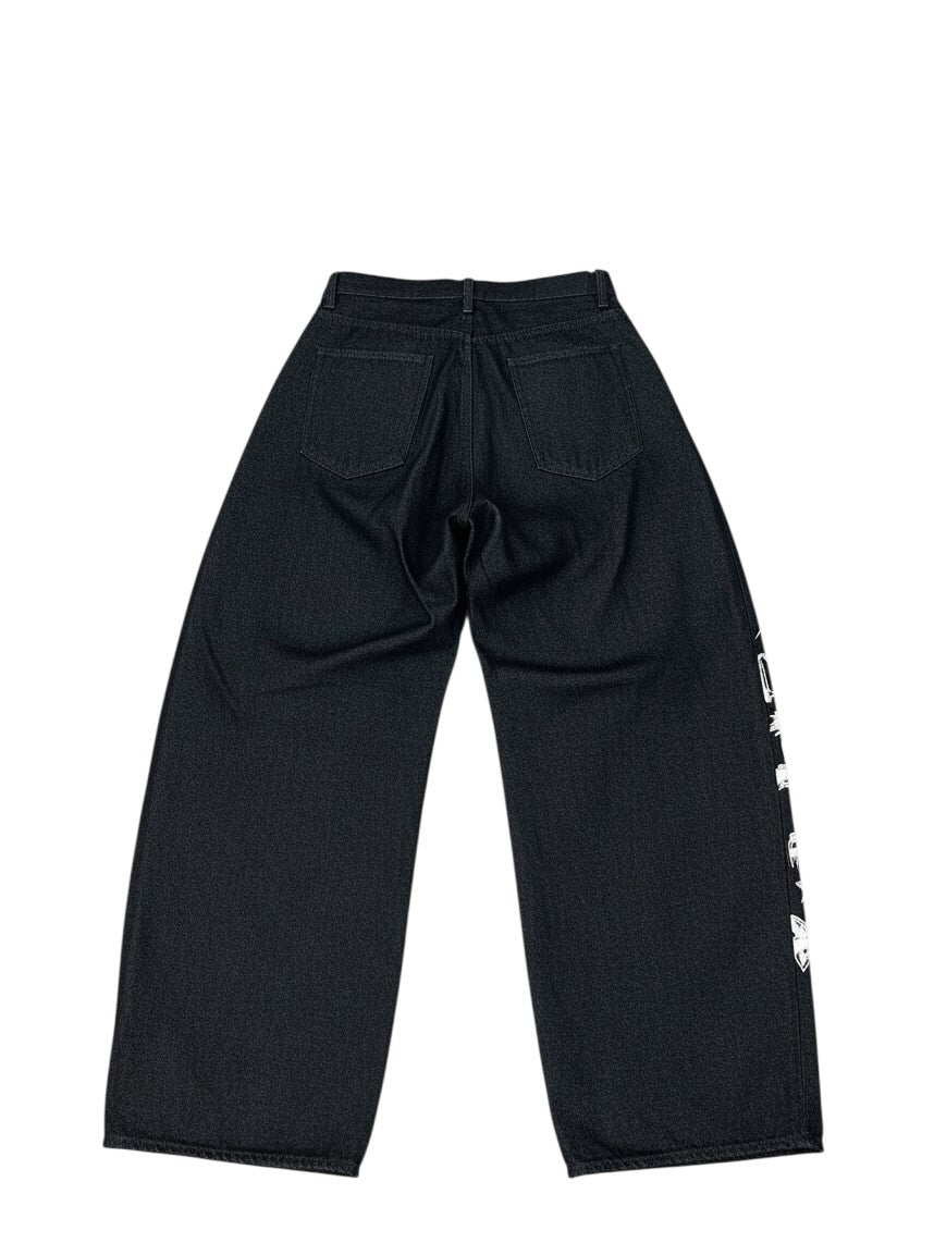 AuraXclusive men's black loose-fit denim jeans with white floral embroidery on the side, back view.