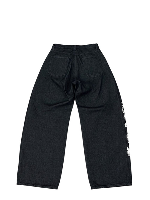 AuraXclusive men's black loose-fit denim jeans with white floral embroidery on the side, back view.
