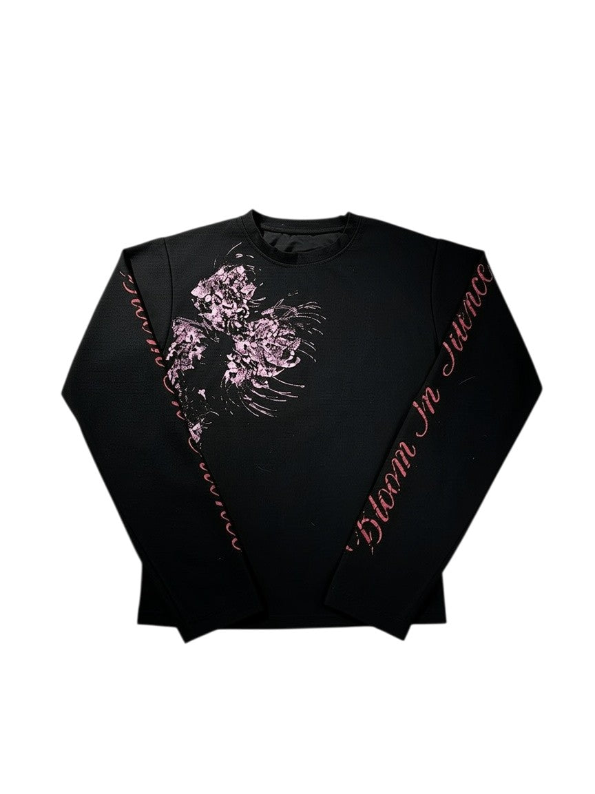 AuraXclusive black long-sleeved crew neck top with pink floral graphic print and Bloom In Silence text on the sleeve.