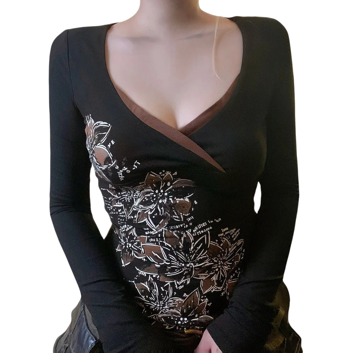 AuraXclusive slim-fit long sleeve top in black with a cross V-neck and white floral graphic print for women.
