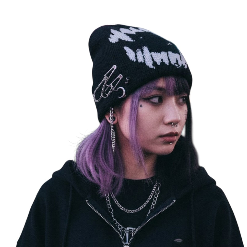 AuraXclusive black knit beanie with white graphic print worn by a person with purple hair in a Y2K streetwear style