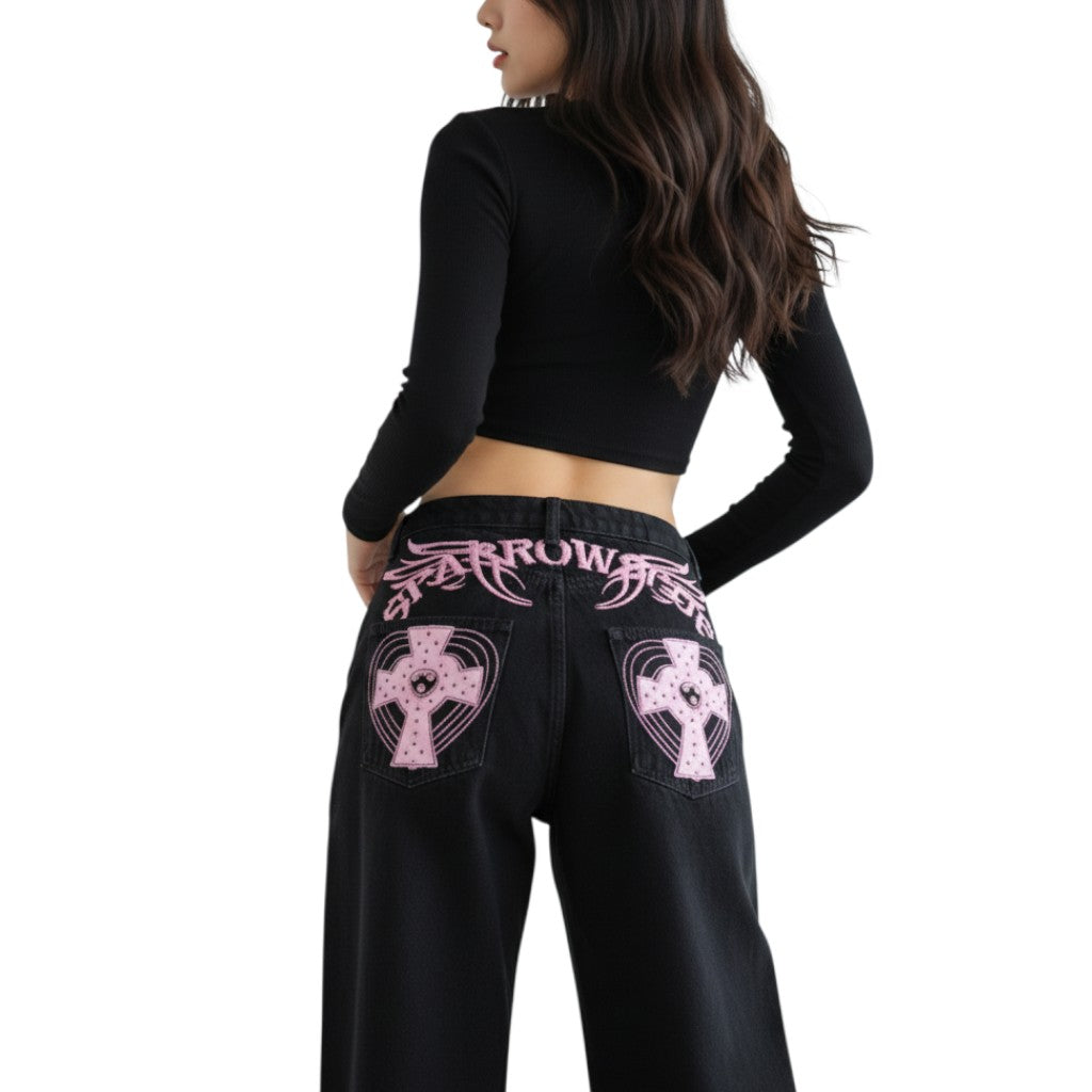 AuraXclusive black loose-fit jeans featuring pink cross appliques and embroidery on the back pockets