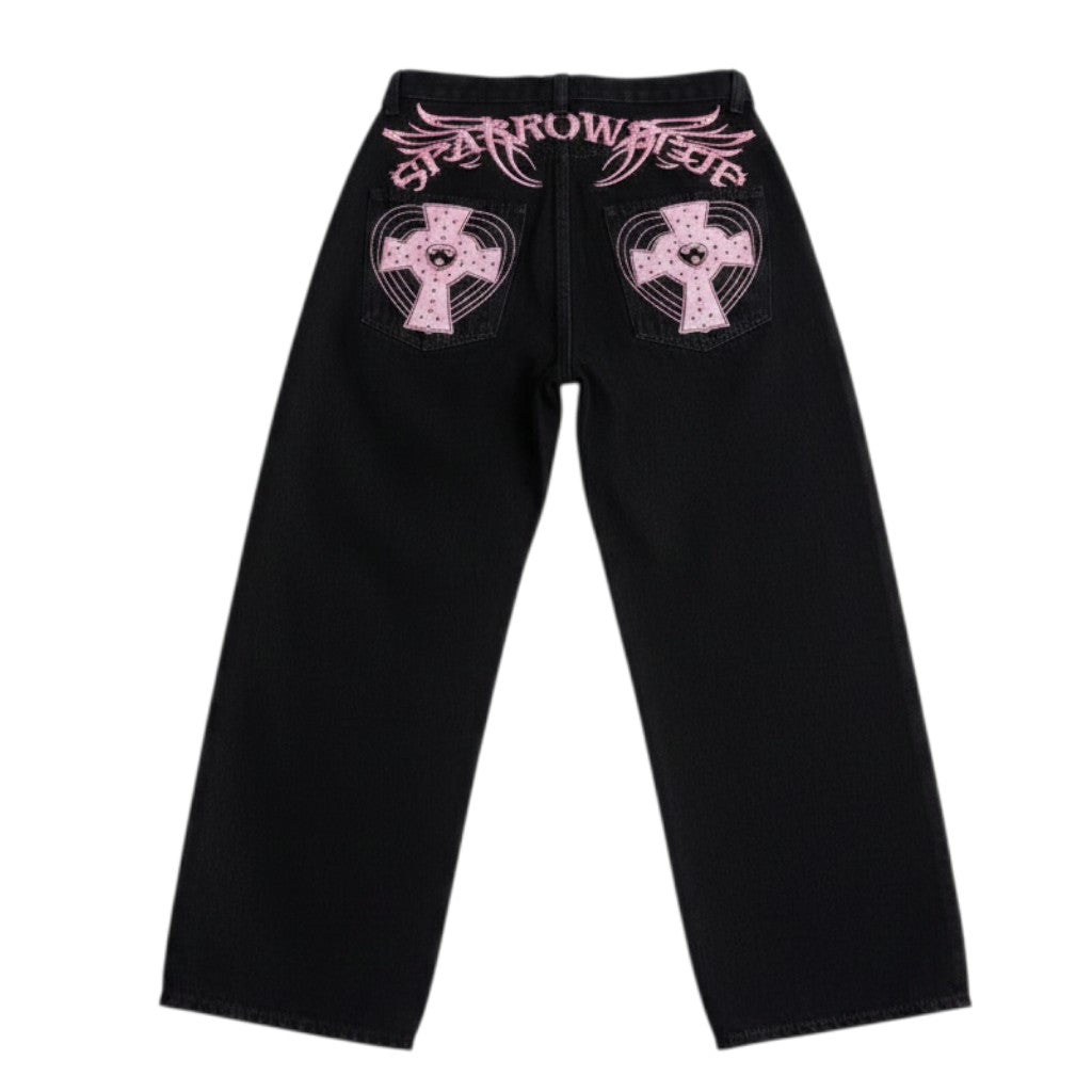 AuraXclusive black loose-fit jeans featuring pink cross appliques and decorative stitching on the back pockets.