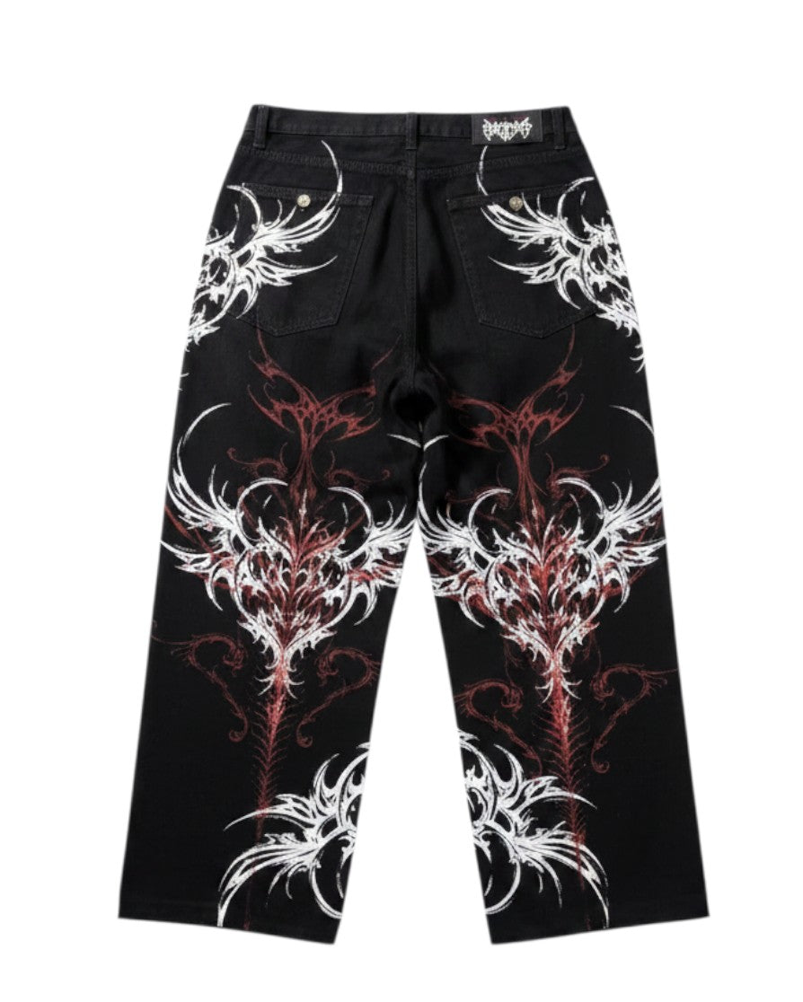 AuraXclusive black baggy jeans featuring a bold red and white tribal flame print in a Y2K gothic streetwear style.