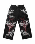 AuraXclusive black wide-leg baggy pants featuring red and white tribal flame print and gothic streetwear design.