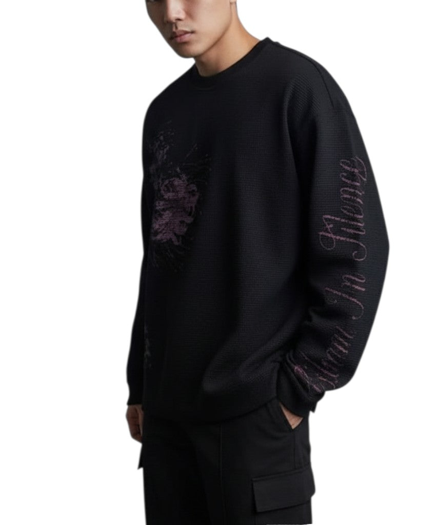 AuraXclusive black long-sleeved waffle knit top with purple graphic print and script lettering on the sleeve