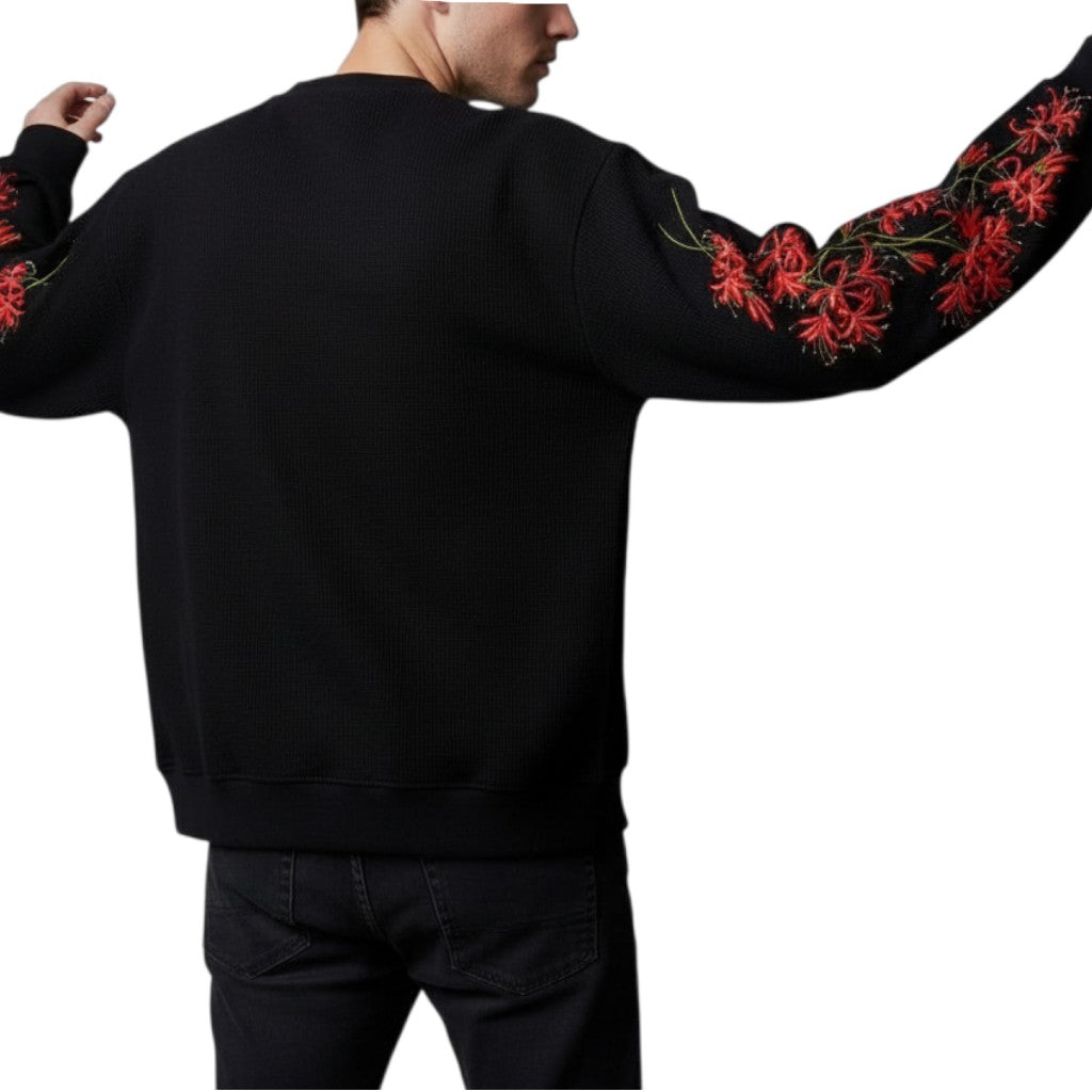 AuraXclusive black waffle knit long sleeve top featuring red cherry blossom graphic prints on the sleeves, back view.