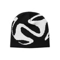 AuraXclusive black and white knit beanie featuring a bold abstract graphic pattern in a Y2k streetwear style.