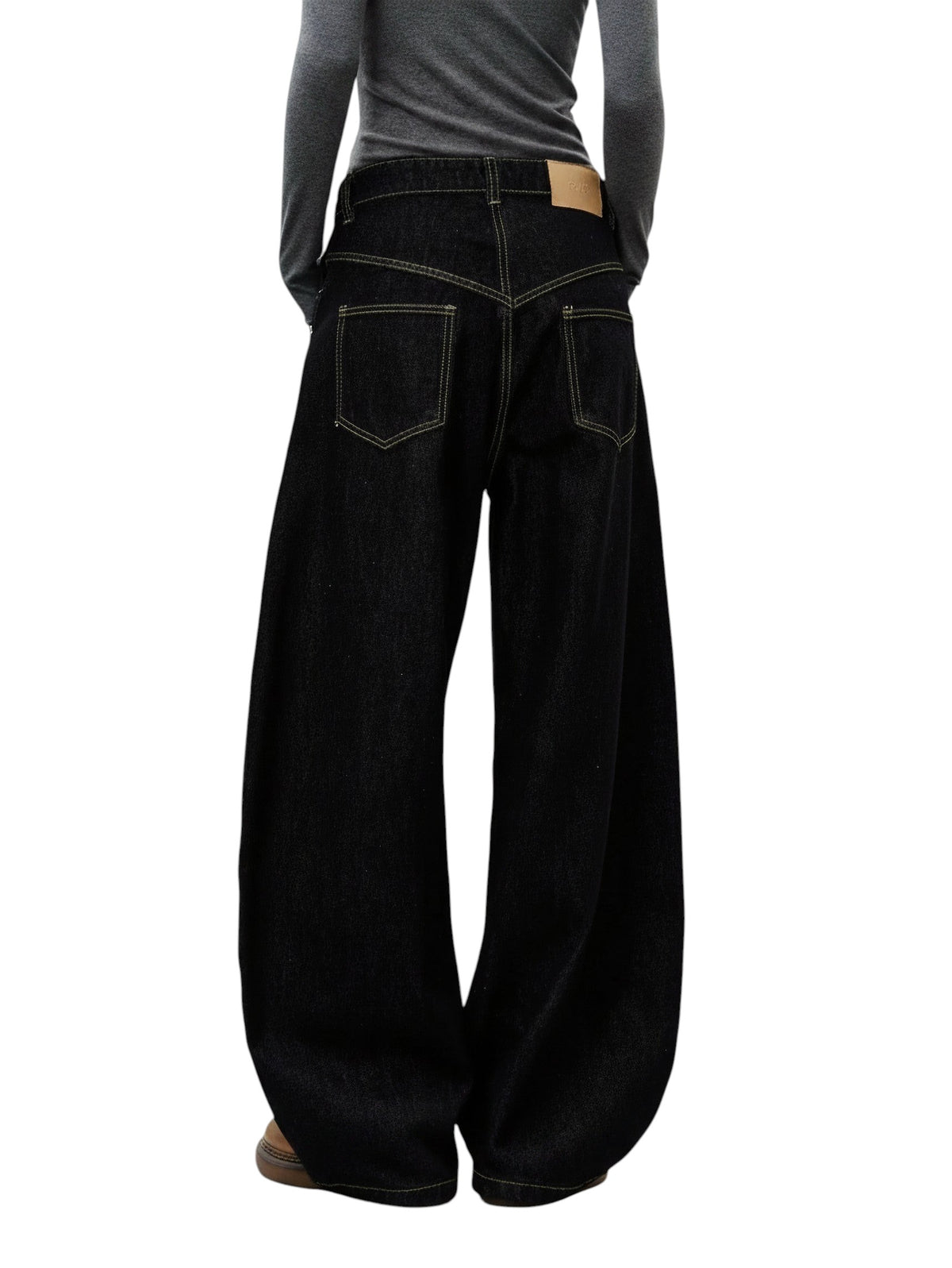 AuraXclusive black wide-leg denim jeans with contrast stitching and a high-rise waist, viewed from the back.