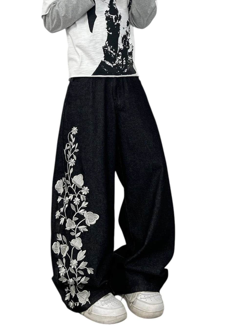 AuraXclusive men's loose black denim jeans featuring intricate white floral embroidery on the leg in Y2K streetwear style
