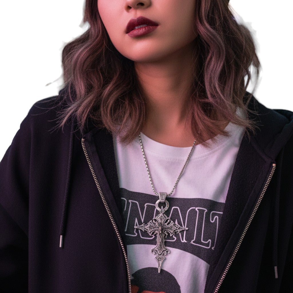 AuraXclusive retro gothic nail cross and skull pendant necklace worn by a model in a black hoodie