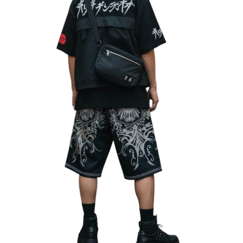 AuraXclusive Rapture denim jorts featuring intricate silver embroidery and print in a loose knee-length streetwear fit
