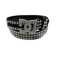 AuraXclusive black PU leather punk belt with silver pyramid studs and a large rhinestone-encrusted DC logo buckle.