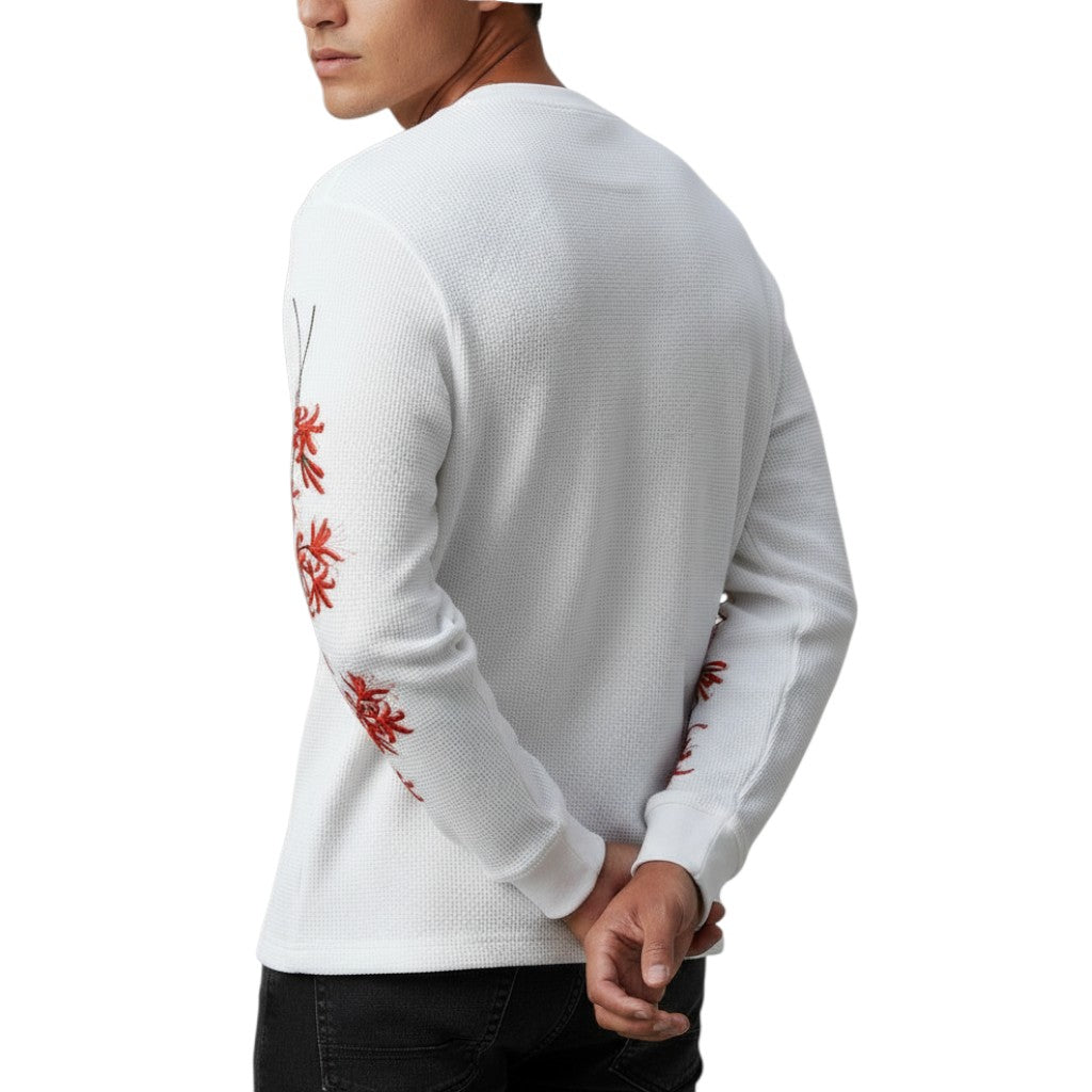 AuraXclusive white waffle knit long sleeve top with red cherry blossom graphic on sleeves worn by a man