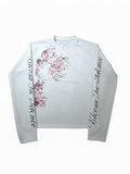 AuraXclusive white long-sleeved waffle knit top featuring a floral print and Bloom In Silence text on the sleeves.